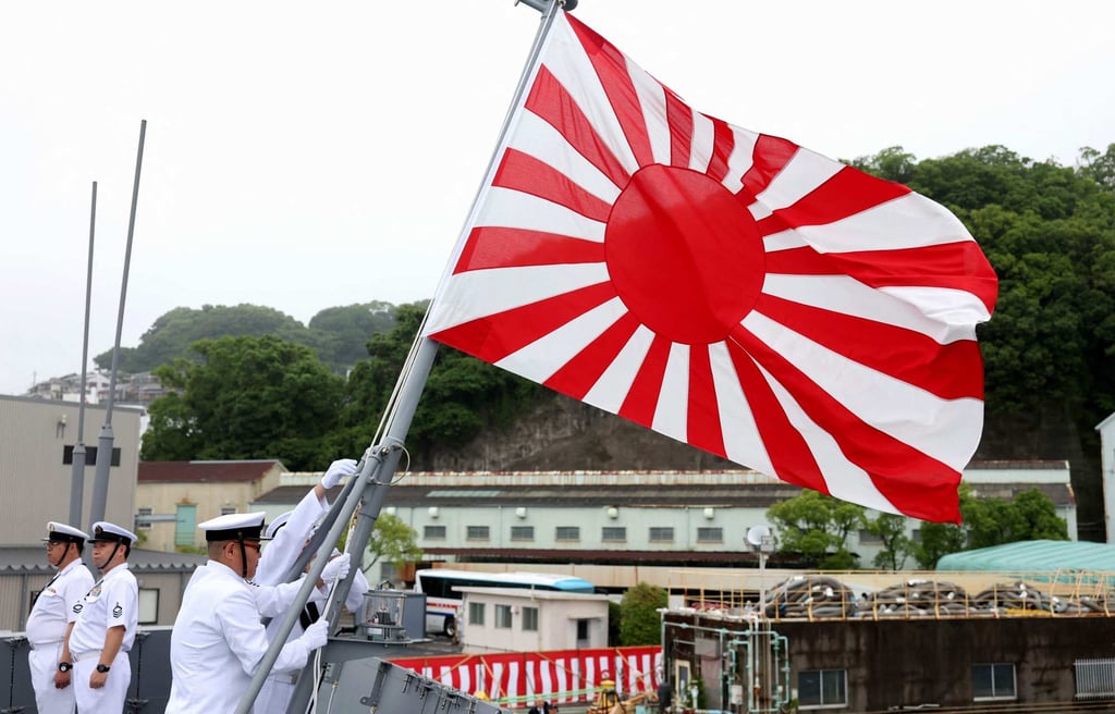 Members of the Japan Maritime Self-Defence Force raise the naval ensign aboard the Mogami-class JS Natori at the Mitsubishi Heavy Industries shipyard in Nagasaki on May 21. Photo: AFP
