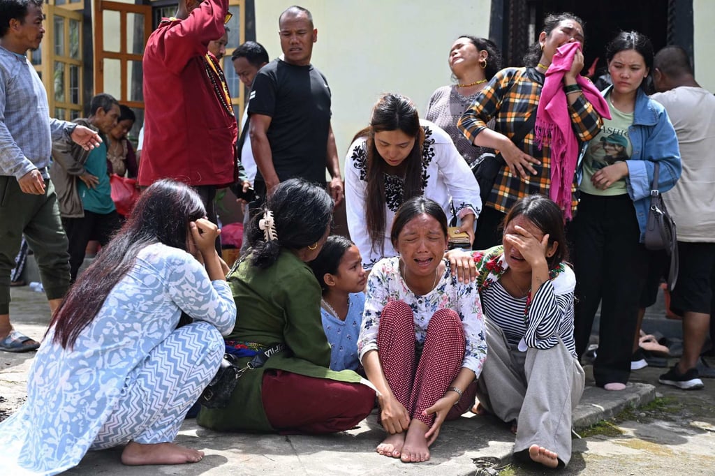 Relatives grieve during a prayer meet held for missing flash flood victims inside a monastery at Trishuli Bazar in Nepal on Wednesday. Photo: AFP Relatives grieve during a prayer meet held for missing flash flood victims inside a monastery at Trishuli Bazar in Nepal on Wednesday. Photo: AFP