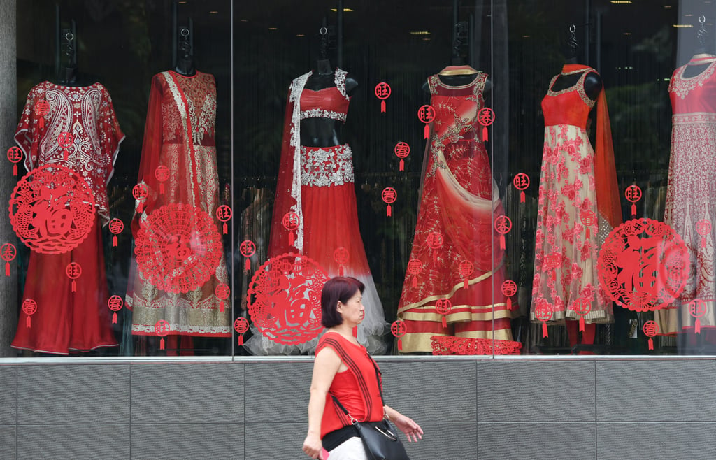 A woman walks past a fashion shop at Singapore’s Little India in February 2018. Photo: Xinhua A woman walks past a fashion shop at Singapore’s Little India in February 2018. Photo: Xinhua