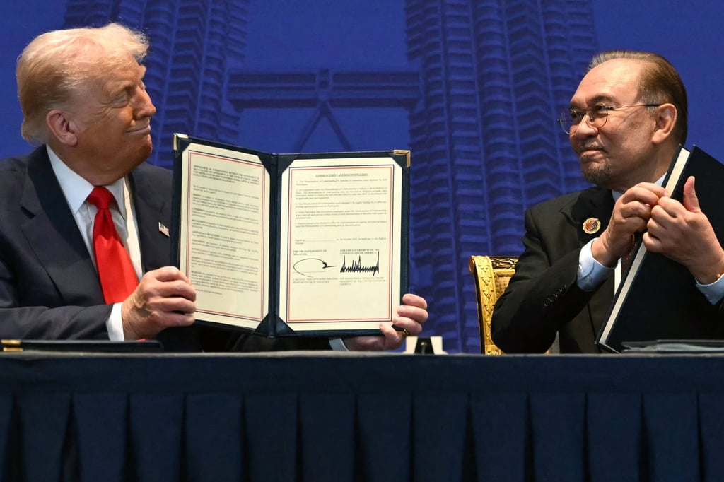 US President Donald Trump and Malaysia’s Prime Minister Anwar Ibrahim hold signed trade documents on the sidelines of last year’s Asean summit in Kuala Lumpur. Photo: AFP