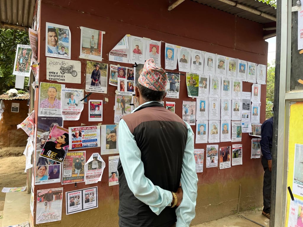 A man observes photos of missing people outside an army camp in Bidur, Nuwakot, Nepal. Photo: Bibek Bhandari