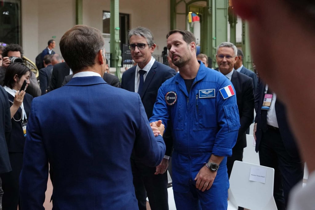 France’s President Emmanuel Macron greets French astronaut Thomas Pesquet (centre) at the International Space Summit at the Grand Palais in Paris on Thursday. Photo: AFP