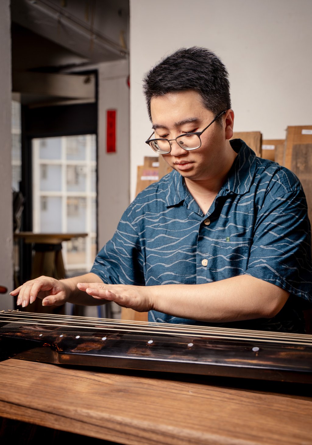 Jackel Wan plays the guqin at the Jockey Club Creative Arts Centre, in Shek Kip Mei. Photo: Alexander Mak Jackel Wan plays the guqin at the Jockey Club Creative Arts Centre, in Shek Kip Mei. Photo: Alexander Mak