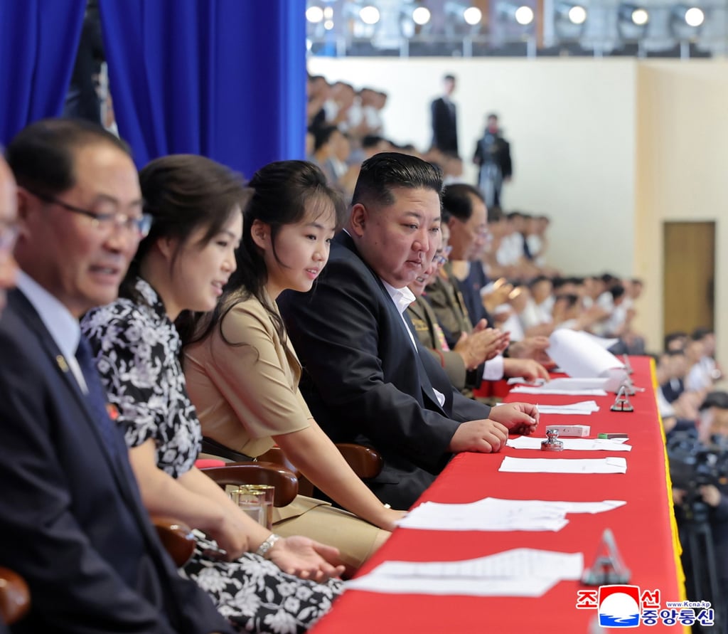 North Korean leader Kim Jong-un (centre), daughter Kim Ju-ae (third from left) and wife Ri Sol-ju (second from left) attend a swimming and diving contest in Pyongyang on August 16. Photo: EPA