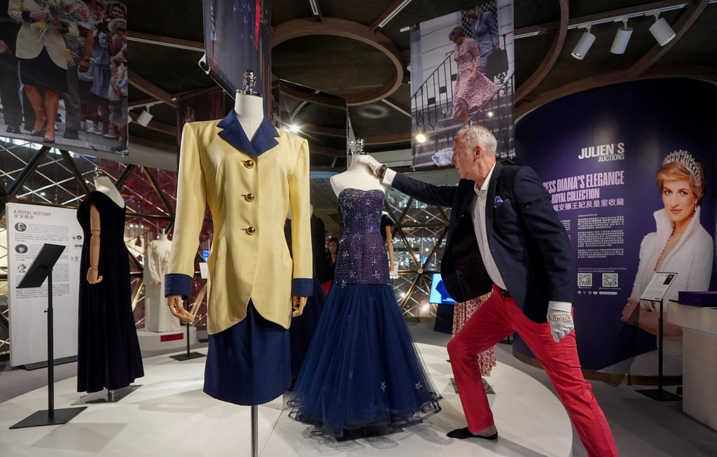 Martin Nolan, co-founder and executive director of Julien’s Auctions, showcases a Catherine Walker skirt suit worn by Princess Diana and a Murray Arbeid midnight blue strapless tulle Diamante Star gown in Hong Kong in April 2024. Photo: Eugene Lee
