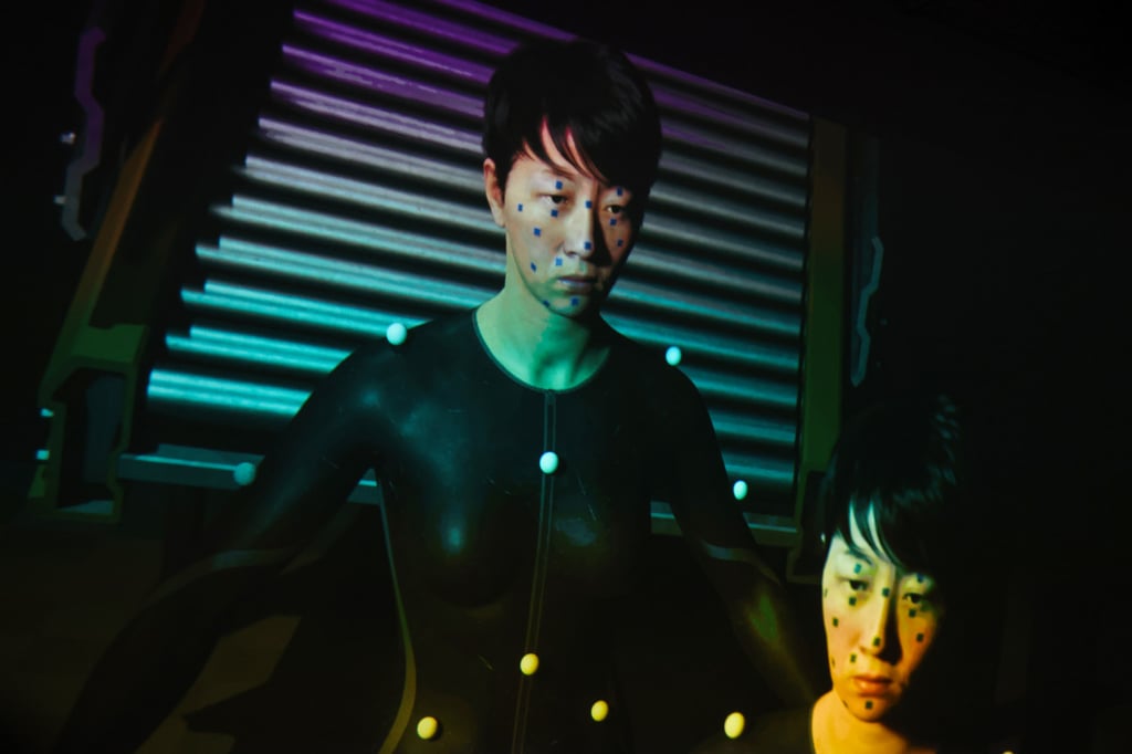 The digital avatar WAI is seen in a still from Lau Wai’s video work The Cast of the Proxy I (2026) at De Sarthe. Photo: Silvia Siu The digital avatar WAI is seen in a still from Lau Wai’s video work The Cast of the Proxy I (2026) at De Sarthe. Photo: Silvia Siu