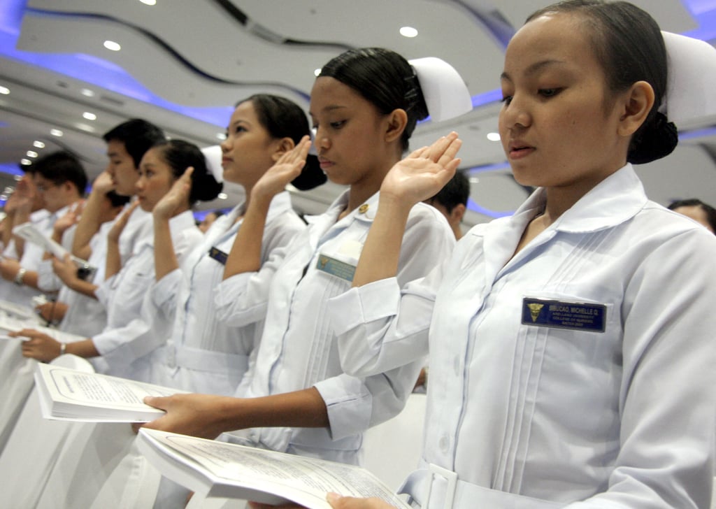 Filipino nurses, many of whom were bound for work abroad as carers, take an oath in Manila in 2009. Filipino carers have become an expensive “gold standard”, according to a recent white paper. Photo: AFP