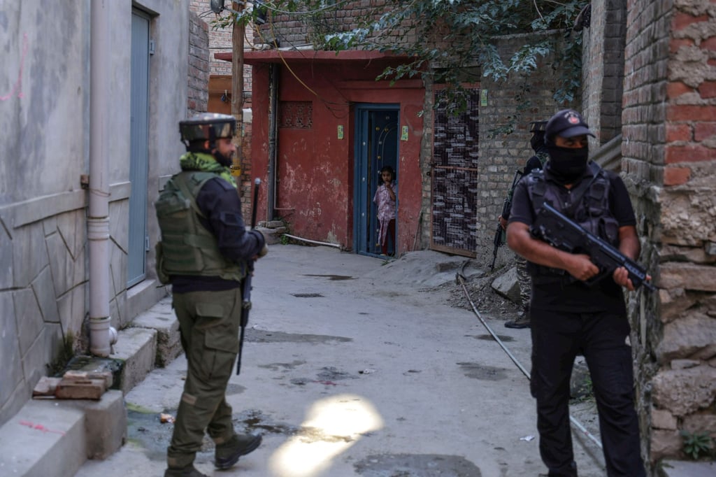 A child looks out as Indian police and paramilitary personnel conduct a search operation in Srinagar, Indian-administered Kashmir, on Saturday. Photo: EPA