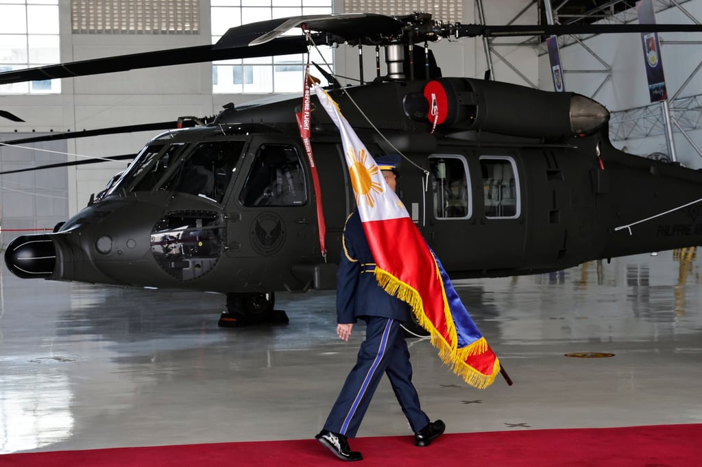 A Philippine Air Force honour guard marches past a newly delivered S-70i Black Hawk helicopter at Villamor Air Base in Metro Manila, in August. Photo: EPA