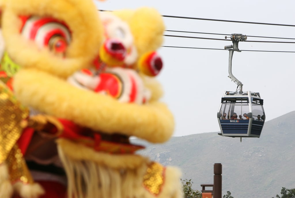 A Ngong Ping 360 cable car passes the lion dance at the official opening ceremony of the cable car service at Hong Kong’s Lantau Island on September 18, 2006. Photo: Robert Ng A Ngong Ping 360 cable car passes the lion dance at the official opening ceremony of the cable car service at Hong Kong’s Lantau Island on September 18, 2006. Photo: Robert Ng