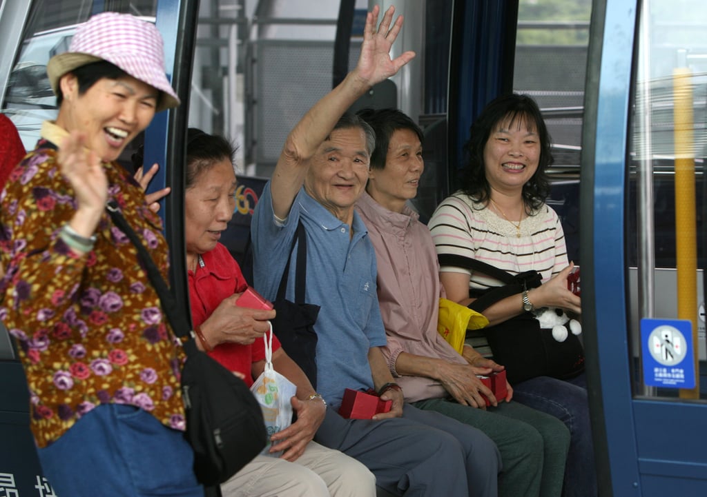 Visitors on board a first cable car at the opening of Ngong Ping 360 cable car on September 18, 2006. Photo: Robert Ng Visitors on board a first cable car at the opening of Ngong Ping 360 cable car on September 18, 2006. Photo: Robert Ng