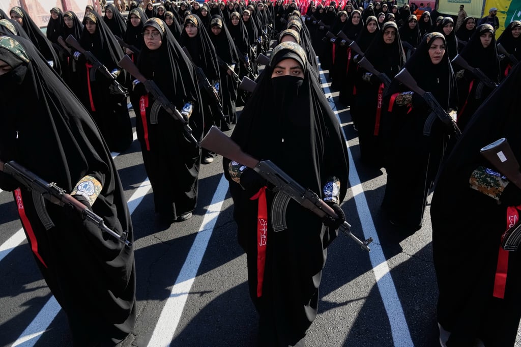 Women affiliated with Iran’s Revolutionary Guard stand during a military-style parade in Tehran, Iran, on Friday. Photo: AP