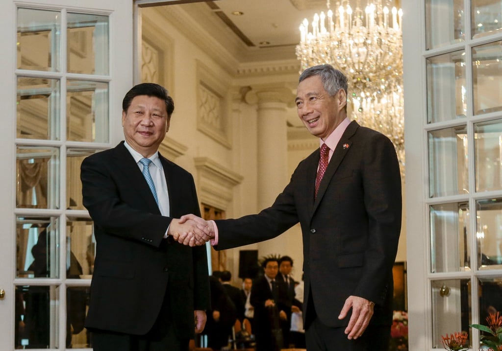 China’s President Xi Jinping and Singapore’s then prime minister Lee Hsien Loong shaking hands at the Istana, the presidential residence, in Singapore on November 7, 2015. The Pinglu Canal runs along the New International Land-Sea Trade Corridor, which was conceptualised under the China-Singapore (Chongqing) Connectivity Initiative endorsed in 2015 by Xi and Lee. Photo: Reuters China’s President Xi Jinping and Singapore’s then prime minister Lee Hsien Loong shaking hands at the Istana, the presidential residence, in Singapore on November 7, 2015. The Pinglu Canal runs along the New International Land-Sea Trade Corridor, which was conceptualised under the China-Singapore (Chongqing) Connectivity Initiative endorsed in 2015 by Xi and Lee. Photo: Reuters