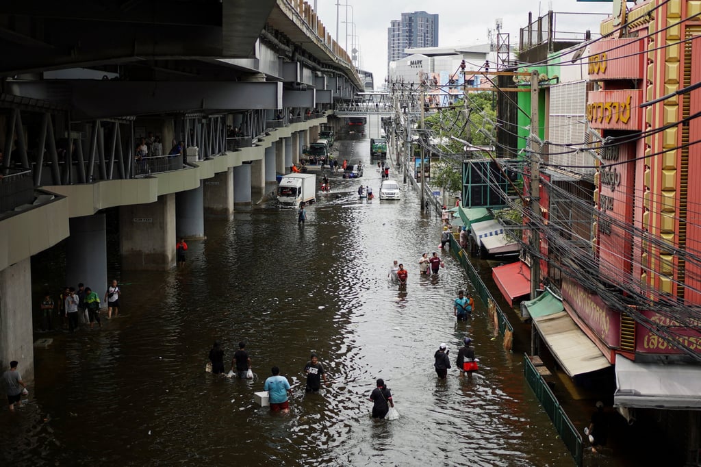 People navigate through a flooded area in Bangkok, Thailand, on Monday. Photo: Reuters People navigate through a flooded area in Bangkok, Thailand, on Monday. Photo: Reuters