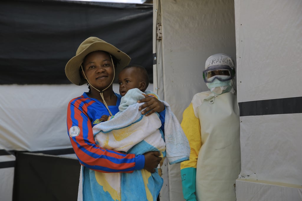 One-year-old Kavugho Mayolo Latifa, whose mother died of Ebola, is carried by her aunt in a treatment centre in Beni, Congo, on Saturday. Photo: AP