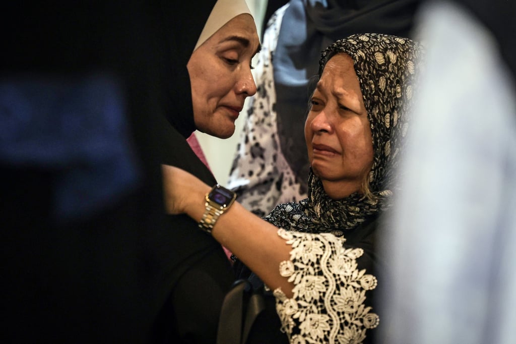Marina Mahathir (right), Mahathir Mohamad and Siti Hasmah’s daughter, is comforted before her mother’s funeral procession in Seri Kembangan. Photo: EPA Marina Mahathir (right), Mahathir Mohamad and Siti Hasmah’s daughter, is comforted before her mother’s funeral procession in Seri Kembangan. Photo: EPA