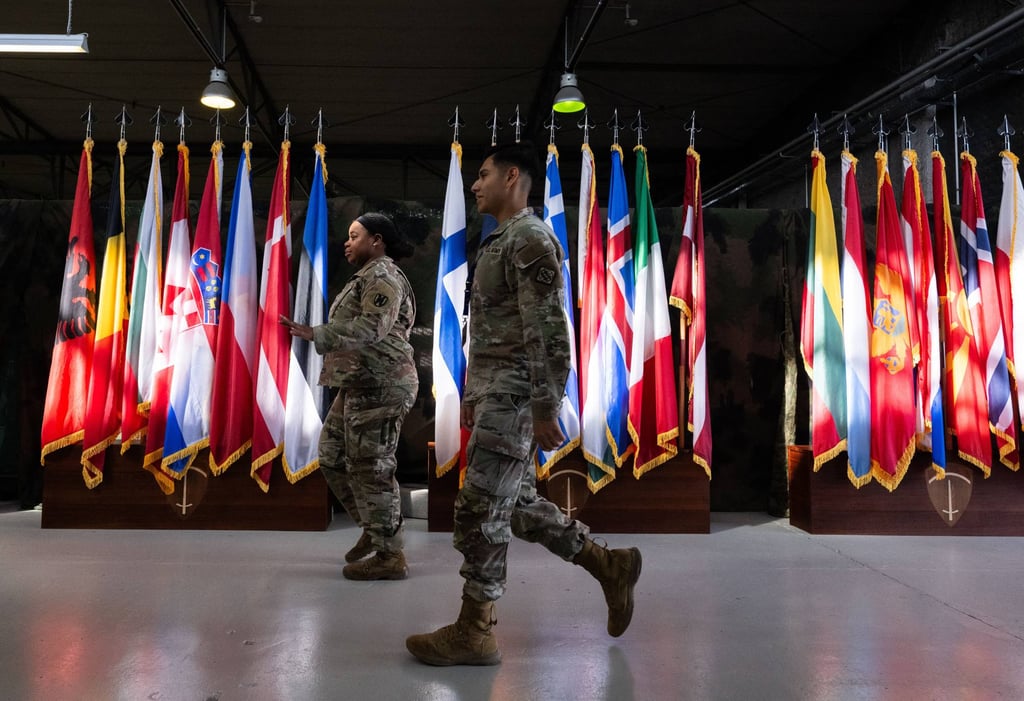 Soldiers walk past flags of Nato member states at the Clay Barracks in Wiesbaden, Germany. Photo: dpa Soldiers walk past flags of Nato member states at the Clay Barracks in Wiesbaden, Germany. Photo: dpa