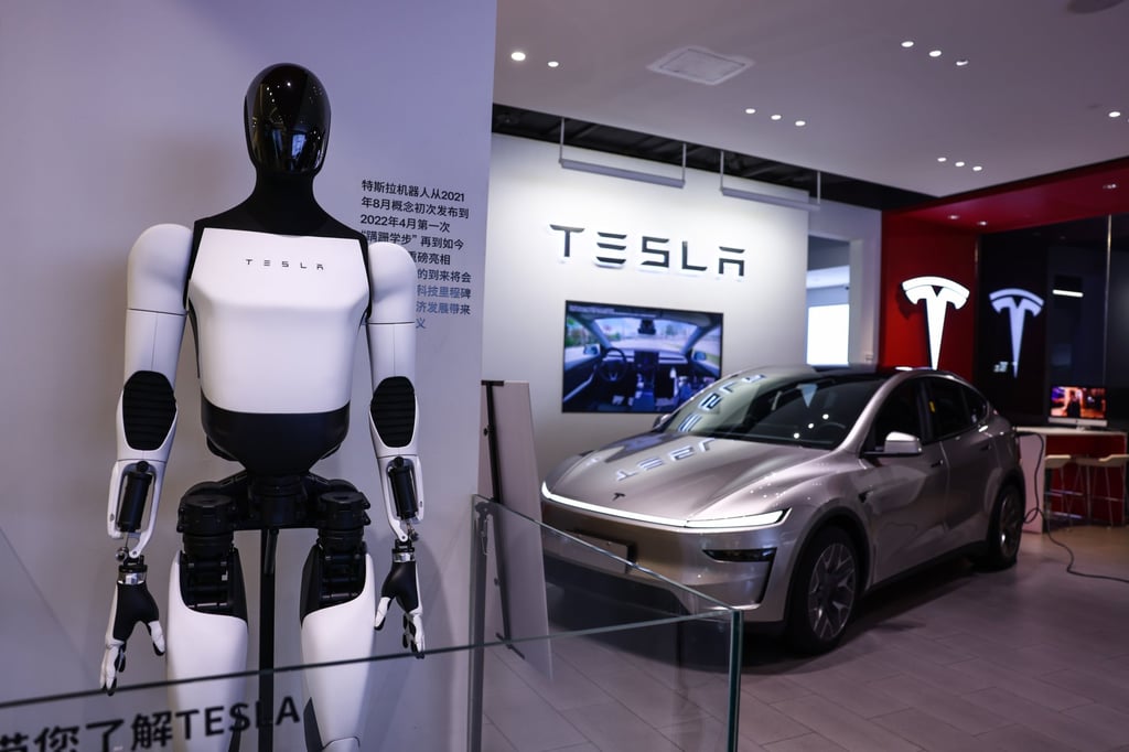 A Tesla humanoid robot and Model Y electric vehicle are displayed in a store in Beijing. Photo: EPA A Tesla humanoid robot and Model Y electric vehicle are displayed in a store in Beijing. Photo: EPA