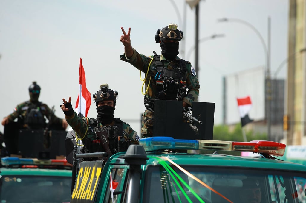 An Iraqi soldier celebrates the withdrawal of US troops in Baghdad on Wednesday. Photo: dpa