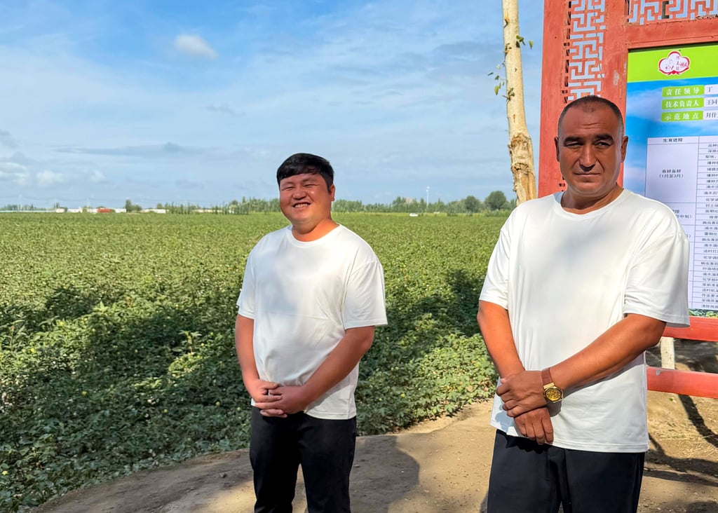 Yusup Molamaiti (left), a 36-year-old technician, says his household income has improved since mechanisation. Photo: Xinlu Liang