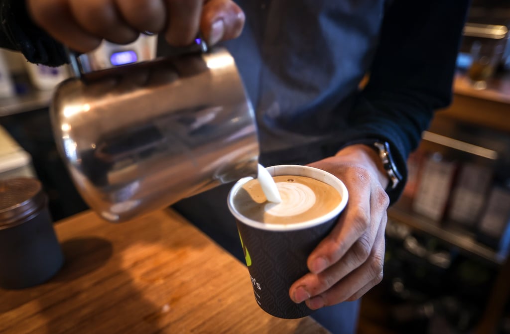 A worker makes coffees for customers in Sydney, Australia, in 2021. Photo: Getty Images. A worker makes coffees for customers in Sydney, Australia, in 2021. Photo: Getty Images.