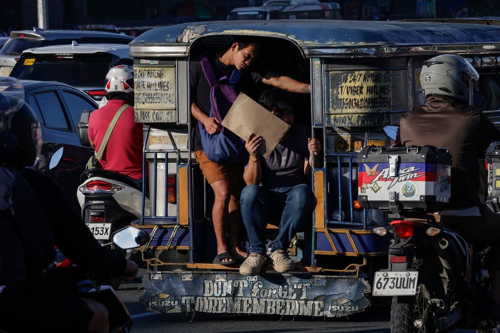 Passengers hold on to the back of a jeepney along a road in Quezon City, Metro Manila, the Philippines, on September 14. Photo: EPA Passengers hold on to the back of a jeepney along a road in Quezon City, Metro Manila, the Philippines, on September 14. Photo: EPA