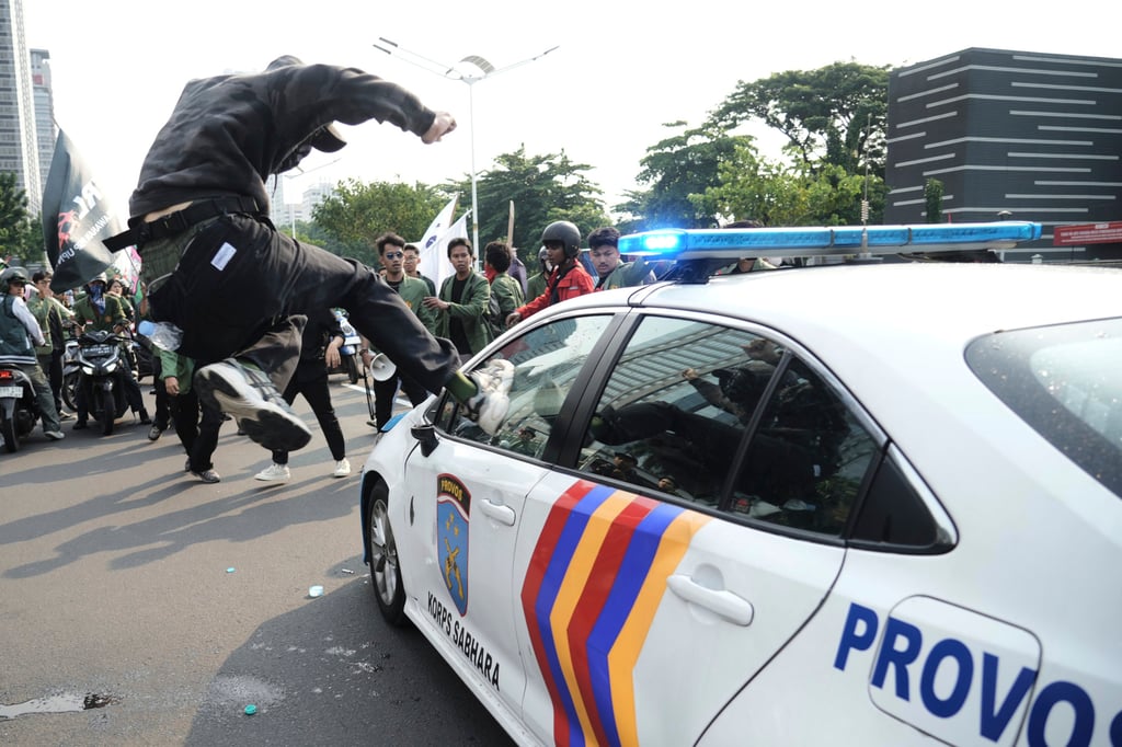A student attacks a police car during a protest in Jakarta in August last year following the death of a delivery rider who was run over by a police vehicle in a rally against lawmakers’ privilege. Photo: AP