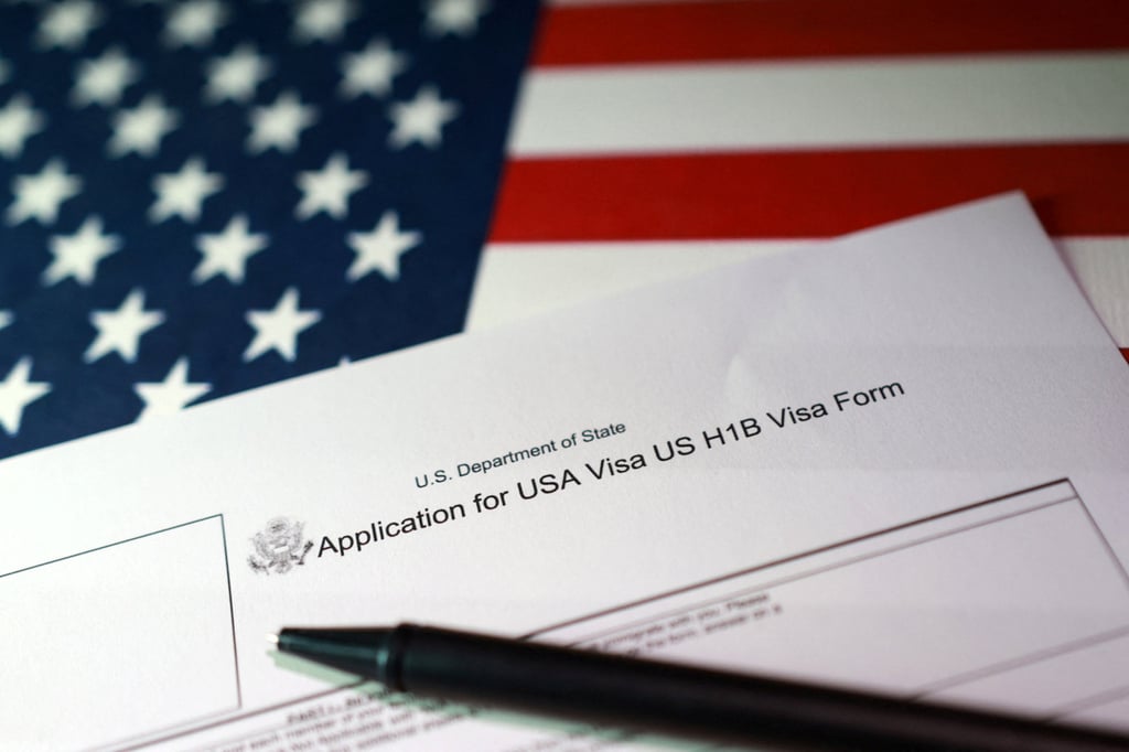 An illustration of a US flag and an H-1B visa application. Photo: Reuters An illustration of a US flag and an H-1B visa application. Photo: Reuters