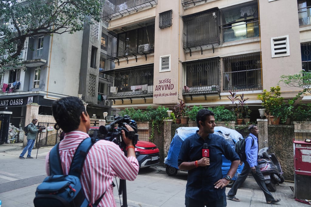 News media personnel stand outside the former residence of flydubai pilot Smit Machchhar’s family in Mumbai, India on Thursday. Photo: AP News media personnel stand outside the former residence of flydubai pilot Smit Machchhar’s family in Mumbai, India on Thursday. Photo: AP
