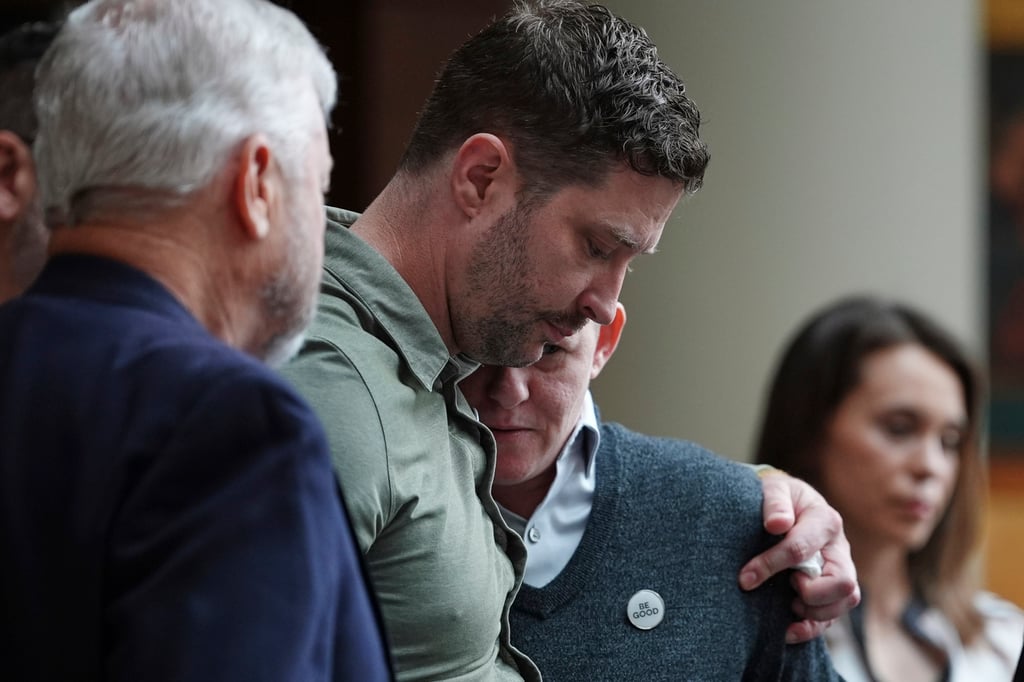 Brent Ganger (second from left) and Becca Good embrace after speaking during a news conference announcing lawsuits against the US government and immigration officials over the killing of Renee Good in Minneapolis on Thursday. Photo: AP