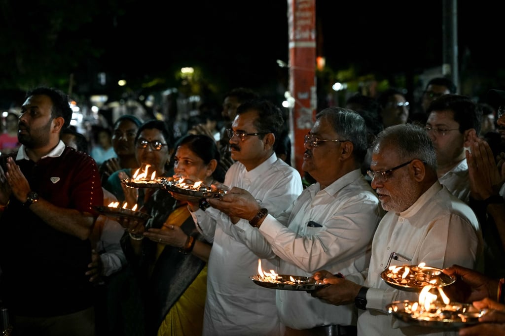 People offer prayers for the recovery of India’s pilot Smit Machchhar, at a temple in Ahmedabad on Thursday. Photo: AFP People offer prayers for the recovery of India’s pilot Smit Machchhar, at a temple in Ahmedabad on Thursday. Photo: AFP