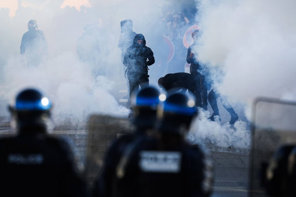 Police officers stand in front of protestors amid tear gas in Brest, western France, on Friday. Photo: AFP Police officers stand in front of protestors amid tear gas in Brest, western France, on Friday. Photo: AFP