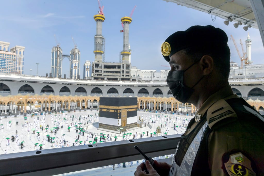 A Saudi security soldier keeps watch as Muslim pilgrims circle the Kaaba in the holy city of Mecca, Saudi Arabia, in 2021. Photo: EPA-EFE A Saudi security soldier keeps watch as Muslim pilgrims circle the Kaaba in the holy city of Mecca, Saudi Arabia, in 2021. Photo: EPA-EFE