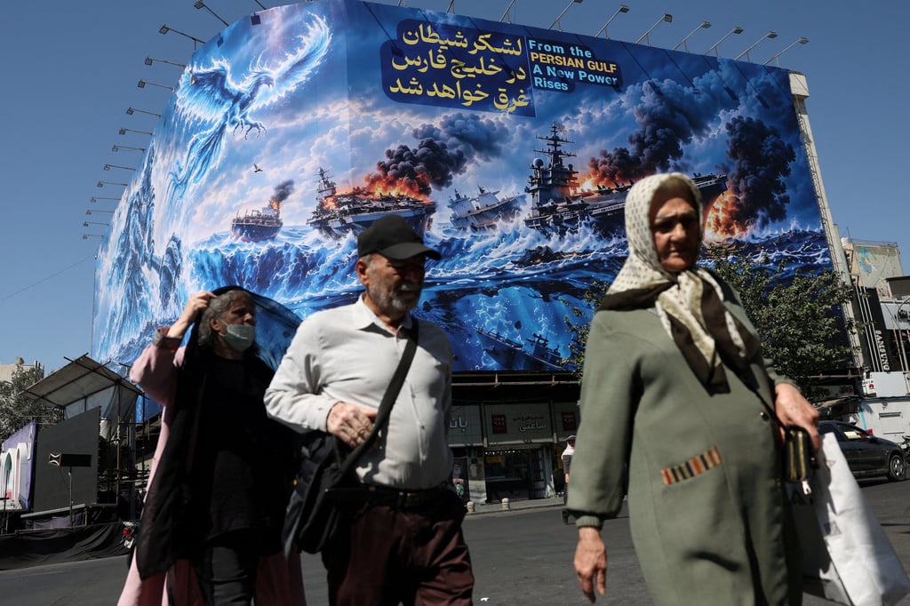 People walk past a Strait of Hormuz billboard on a building in Tehran last month. Photo: WANA via Reuters People walk past a Strait of Hormuz billboard on a building in Tehran last month. Photo: WANA via Reuters