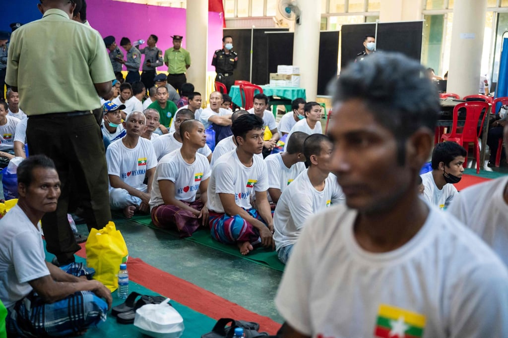Myanmar migrants repatriated from Malaysia sit together at a temple during their official welcoming process in Thanlyin on April 10, 2026. Photo: AFP