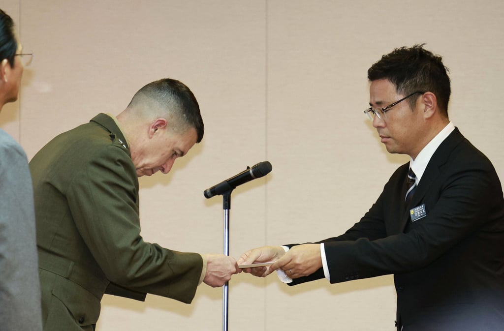 Okinawa governor Genta Koja hands a letter of protest to US Marine Corps lieutenant general Benjamin T. Watson at the Okinawa prefectural office in Naha on Monday. Photo: Kyodo/AP