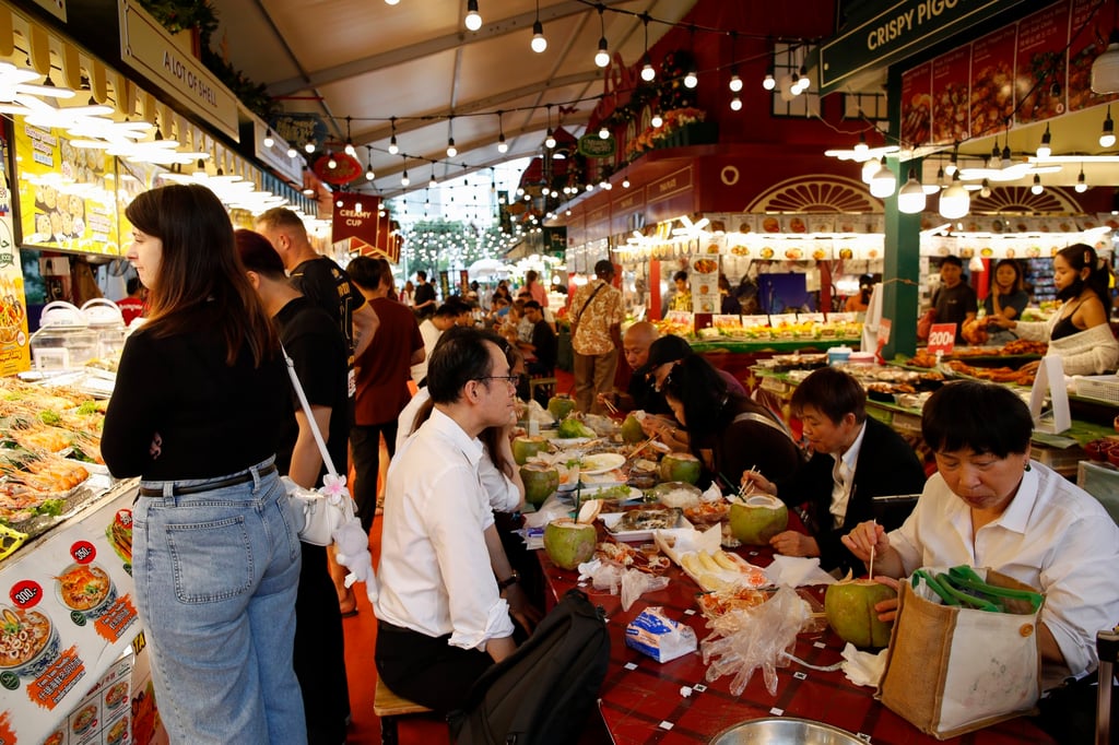 Foreign tourists enjoying street food at a street food market in Bangkok. Photo: EAP