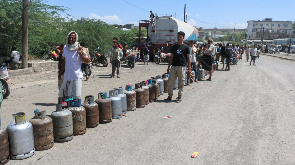 People queue with cooking gas cylinders as they wait to get them refilled, amid shortages of supply in Taiz, Yemen, on Monday. Photo: Reuters