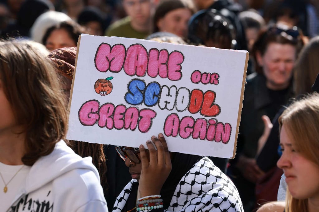 A pupil holds a placard during a protest in Saint-Denis, north of Paris on Sunday. Photo: AFP