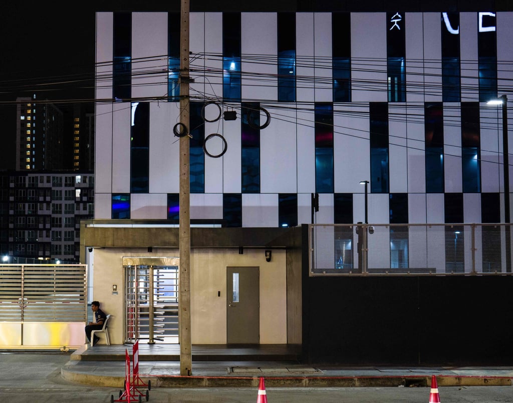 A security guard sits outside a data centre building in Bangkok on September 4. Photo: AFP