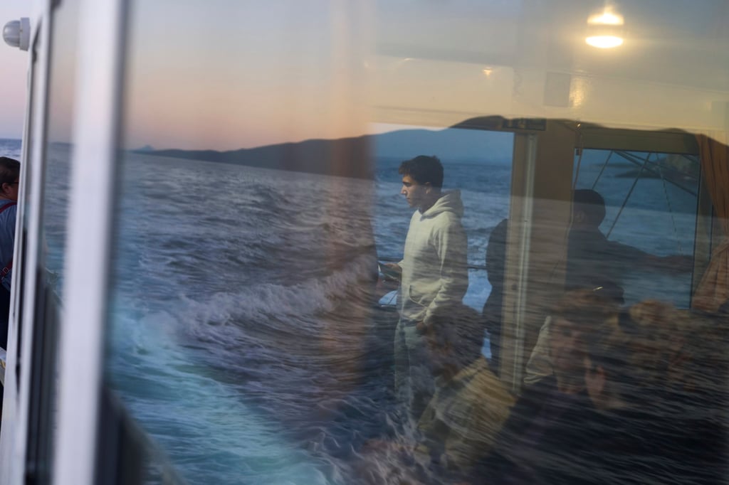 High school student Antonis Aivaliotis (centre) travels by boat across the Ionian Sea from Kalamos to school in the mainland town of Mytikas, western Greece, on September 24. Photo: AP