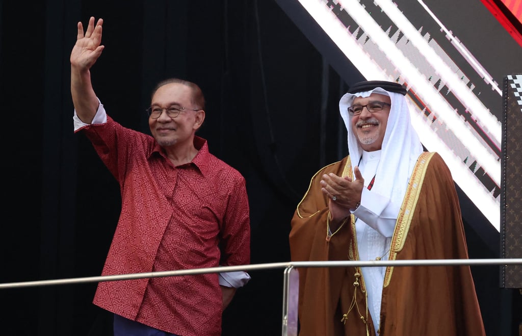 Malaysia’s Prime Minister Anwar Ibrahim waves to the crowd at Sepang International Circuit on Sunday alongside his Bahraini counterpart Crown Prince Salman bin Hamad Al Khalifa. Photo: Reuters