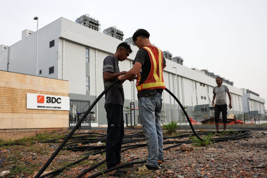 Workers lay cables outside Bridge Data Centres in Johor, Malaysia, on May 6. Photo: Reuters