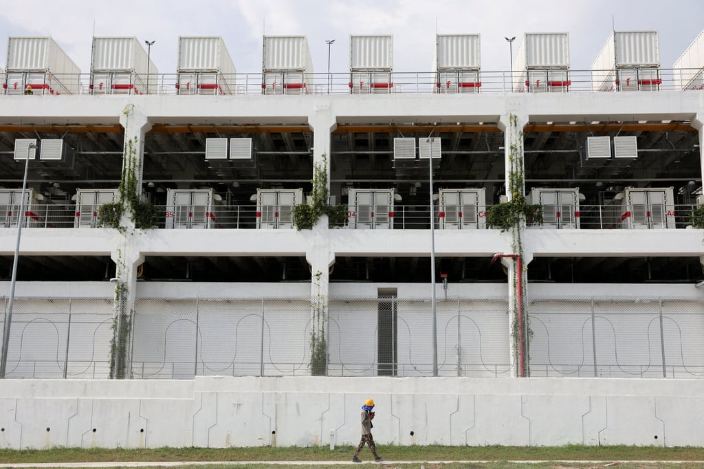 A worker walks past a data centre in Malaysia’s Johor state in May. Photo: Reuters A worker walks past a data centre in Malaysia’s Johor state in May. Photo: Reuters