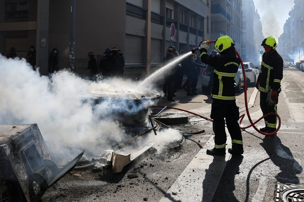 Firefighters douse smouldering elements of a street barricade in water, amid a French high school and university students’ demonstration in Lyon on Tuesday. Photo: Reuters Firefighters douse smouldering elements of a street barricade in water, amid a French high school and university students’ demonstration in Lyon on Tuesday. Photo: Reuters