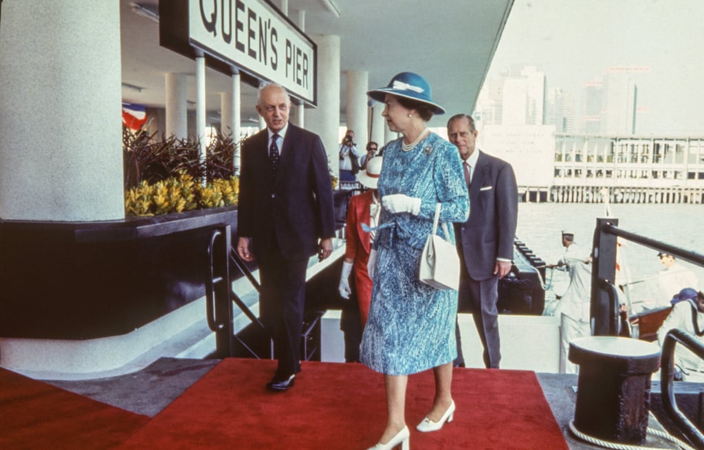 Queen Elizabeth arrives at Queen’s Pier in Central on October 21, 1986. She is accompanied by Hong Kong’s then governor Sir Edward Youde (left), and Prince Philip, the Duke of Edinburgh (back). File photo: SCMP