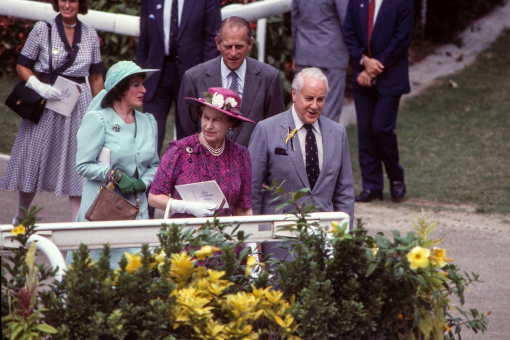 Queen Elizabeth visits the Sha Tin racecourse with Sir Michael Sandberg (right), chairman of the Royal Hong Kong Jockey Club, and Prince Philip, the Duke of Edinburgh (back). File photo: SCMP