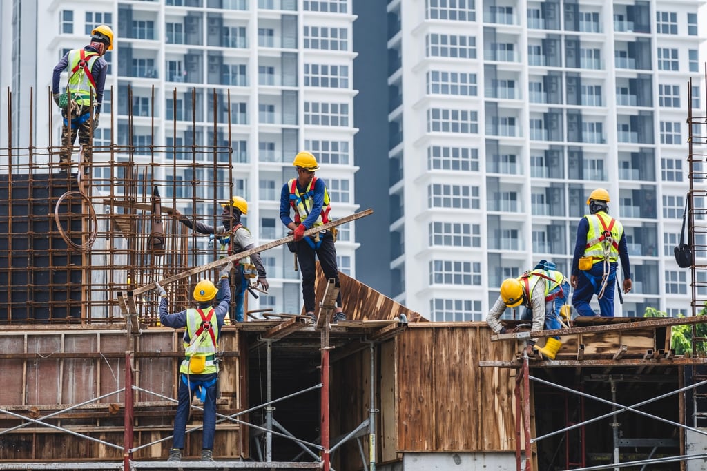 Construction workers at a high-rise building site in Kuala Lumpur, Malaysia, in 2024. Physically demanding jobs make extending working lives difficult for ageing lower-income Malaysians. Photo: Shutterstock