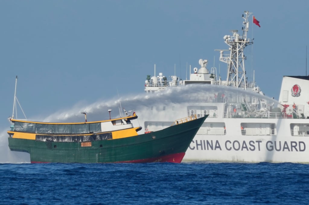 A Chinese coastguard vessel sprays water at a Philippine ship in the South China Sea in March 2024. Photo: AP A Chinese coastguard vessel sprays water at a Philippine ship in the South China Sea in March 2024. Photo: AP