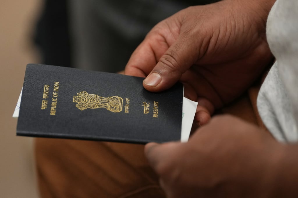 A worker holds his passport. Photo: AP